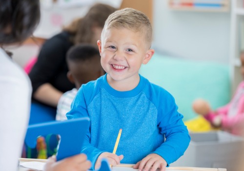 Smiling child making a drawing in daycare in Peoria IL
