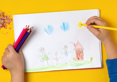 A child drawing a picture of their family at a Peoria Preschool