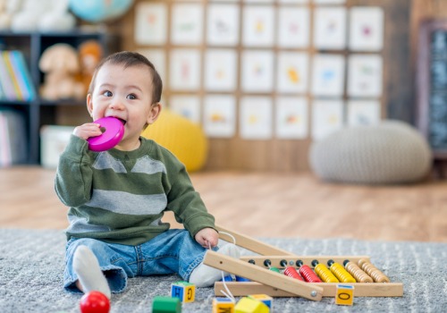 A baby playing with chewing toys at the Best Infant Care in Peoria IL