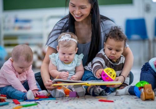 An instructor playing with babies in Child Care in East Peoria IL