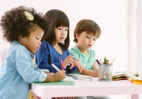 Pre-K kids sit at a table coloring at PALS, the Best Pre-K in Peoria County IL
