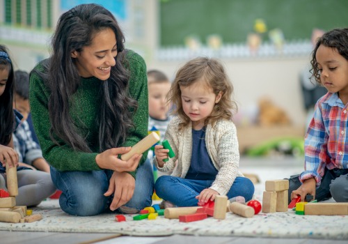 A teacher plays games with children at PALS, which is a Childcare Development Center for Peoria Heights IL residents