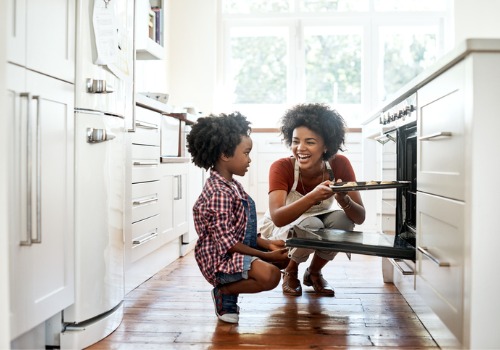 A mother and child bake cookies together. Spending time together is one way you can begin creating a nurturing environment at home.