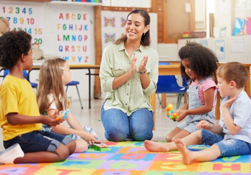 A teacher sings with toddlers at PALS, a Top Preschool in Peoria County IL