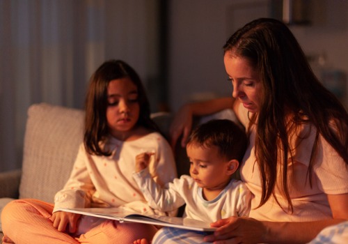 A mother tells a story to her children at night, which is a great way to maintain routines during the holidays