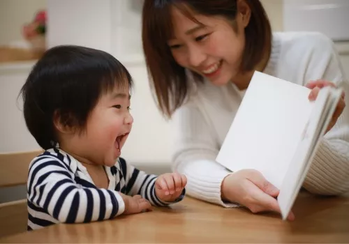 A mother reads with her toddler as part of their Snowday Survival Guide